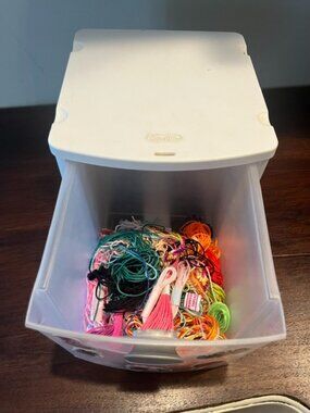 Box with colorful yarn, used for making crafts.